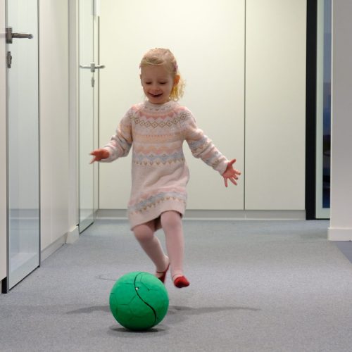 Girl chasing rolling fizzy